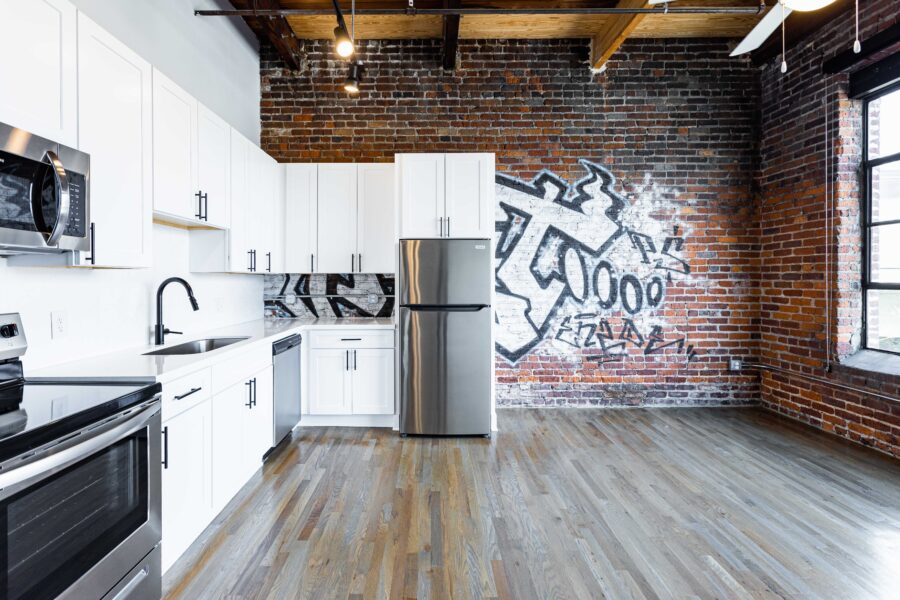 open apartment kitchen with exposed brick walls