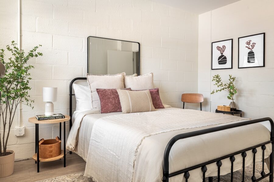 bedroom with plants on either side of the bed