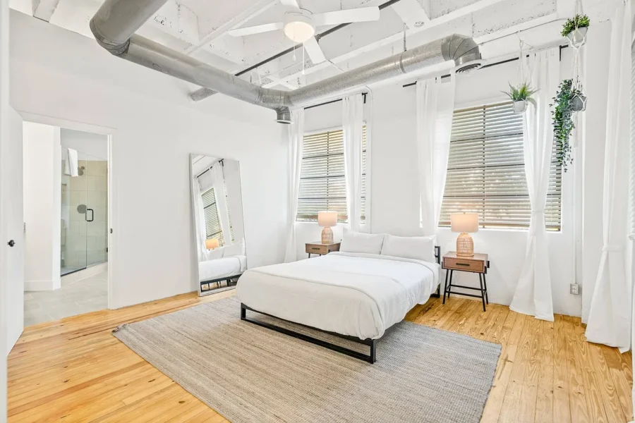 bedroom with high ceilings and wood floors