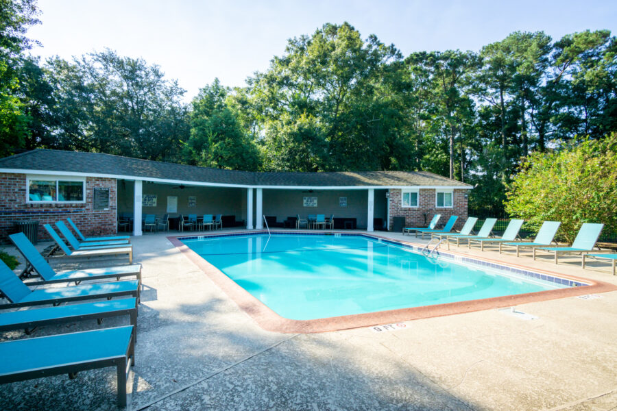 large swimming pool with lounge chairs around it