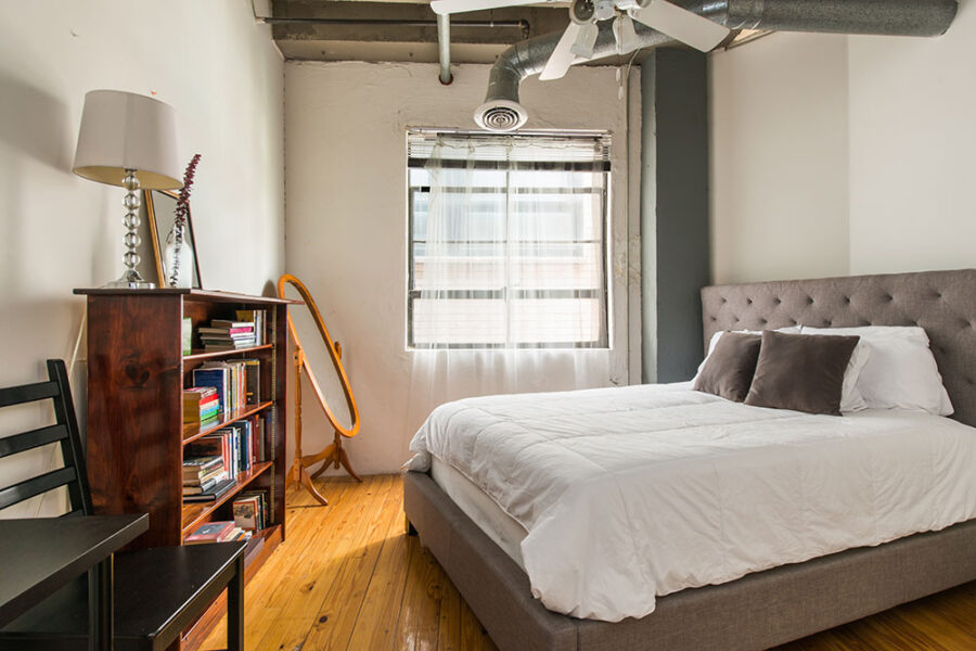 a bedroom with wood floors