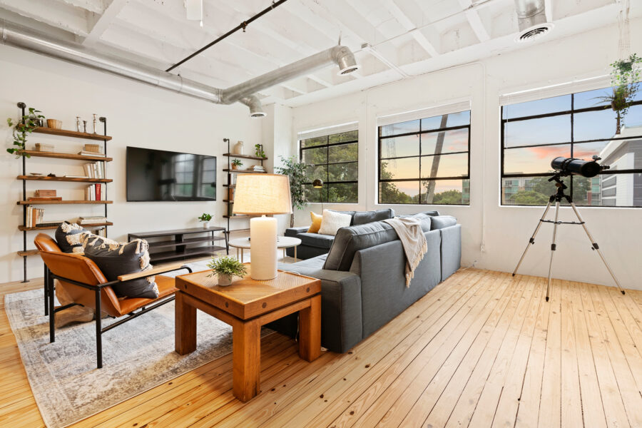 living room with large windows and view of the sunset