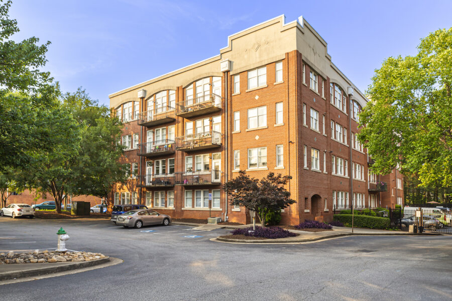 large apartment building on a street corner