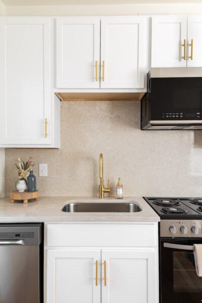 apartment kitchen with white countertops and cabinets